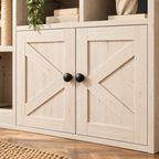 Close-up of the farmhouse-style X-panel cabinet doors and black knobs on the white cat furniture