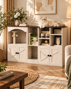 Close lifestyle view of the white and walnut cat cabinet showing open storage shelves, dark wood top and integrated cat nook